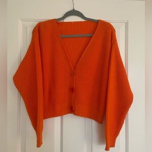 Orange short cardigan.